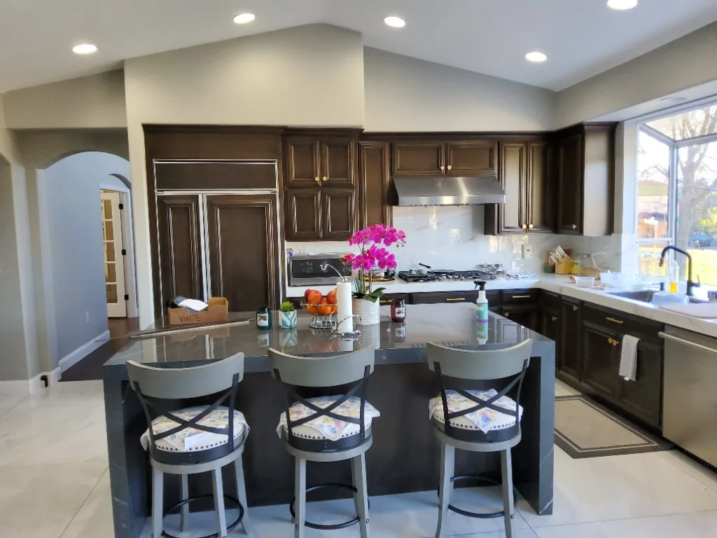 Espresso kitchen cabinetry with waterfall island